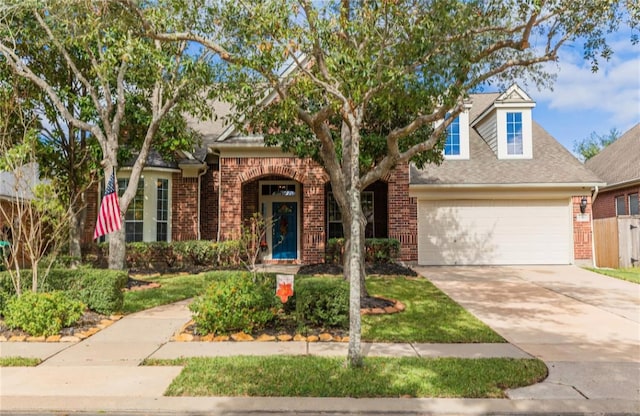 23702 Whispering Wind, Katy, TX 77494 - traditional-style house with brick siding, concrete driveway, and a shingled roof