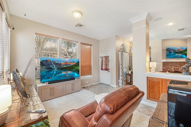 23702 Whispering Wind, Katy, TX 77494 - living area with light tile patterned floors, a brick fireplace, and ornate columns