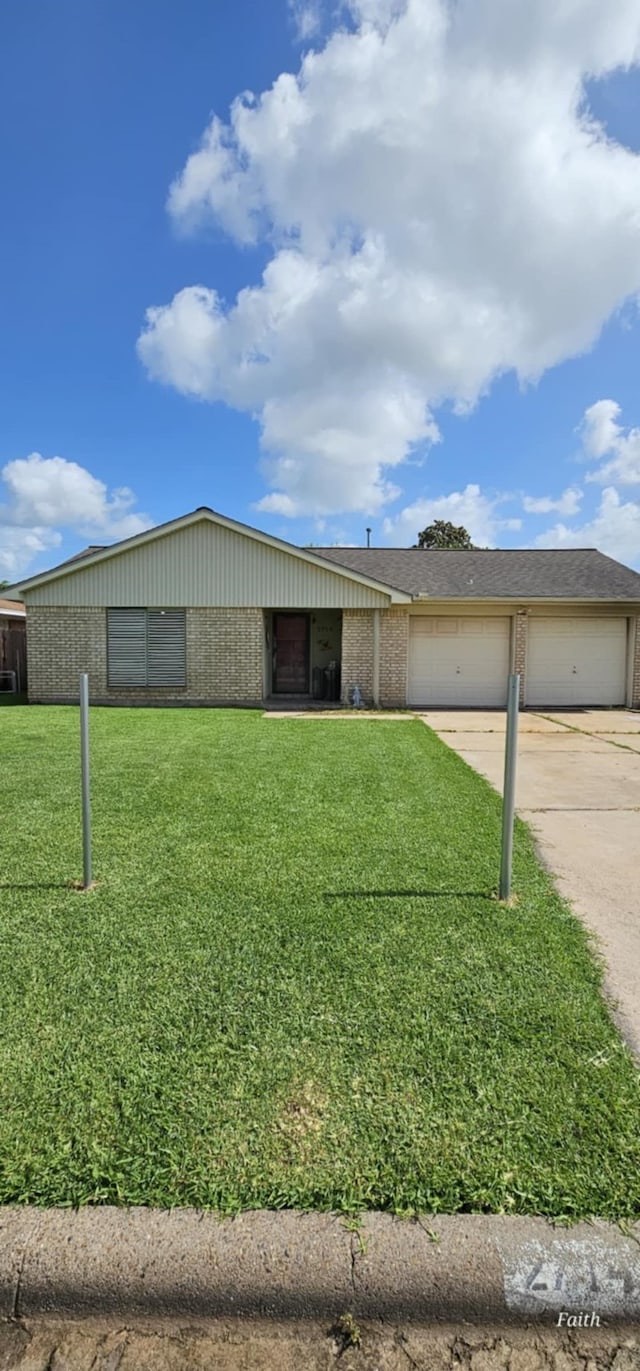 2714 6th Ave N, Texas City, TX 77590 - view of front of house with brick siding, concrete driveway, a garage, and a front lawn