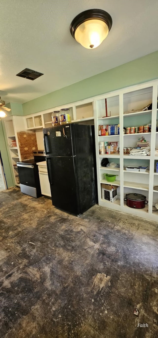 2714 6th Ave N, Texas City, TX 77590 - kitchen featuring freestanding refrigerator, a ceiling fan, and concrete flooring