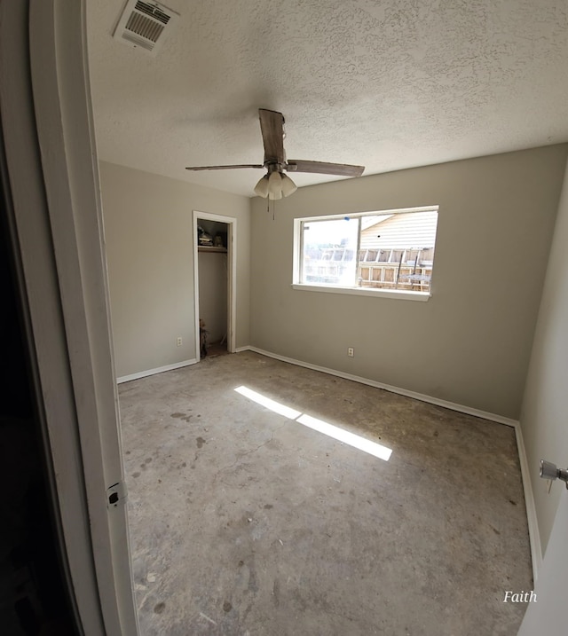 2714 6th Ave N, Texas City, TX 77590 - unfurnished bedroom featuring a textured ceiling, a closet, a ceiling fan, and concrete floors