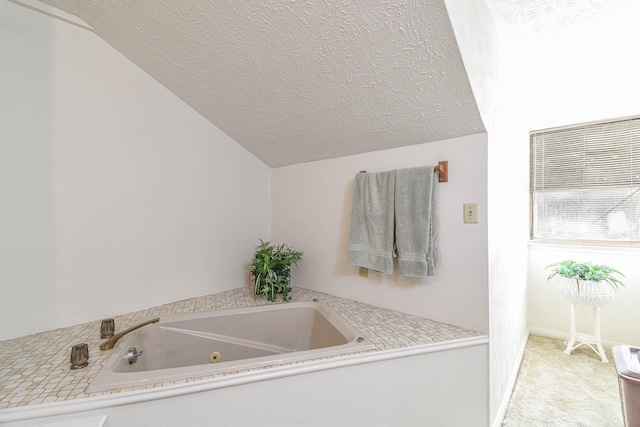 4503 Allen Genoa Rd, Pasadena, TX 77504 - bathroom with vaulted ceiling, a textured ceiling, and a whirlpool tub