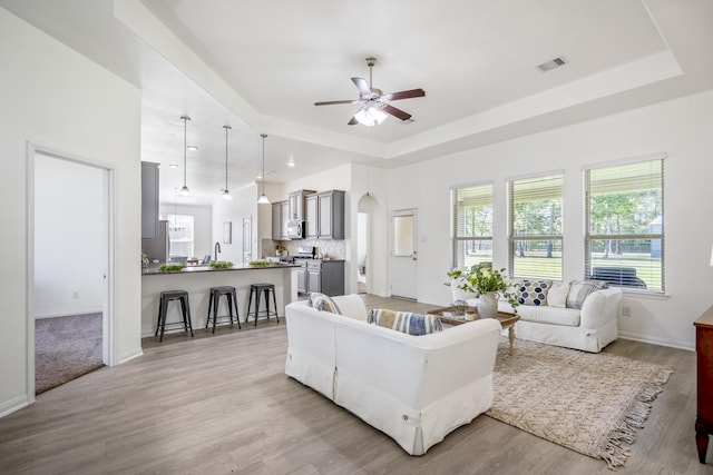 16070 Deer Pines Dr, Conroe, TX 77303 - living room with a ceiling fan, a raised ceiling, light wood-style floors, and recessed lighting
