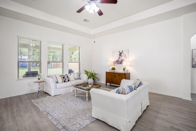 16070 Deer Pines Dr, Conroe, TX 77303 - living room featuring ceiling fan, wood finished floors, arched walkways, and a tray ceiling