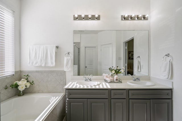 16070 Deer Pines Dr, Conroe, TX 77303 - bathroom featuring double vanity, a bath, and a shower with door
