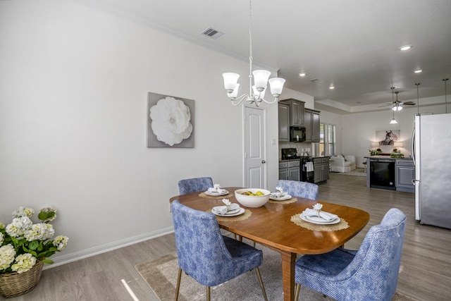 16070 Deer Pines Dr, Conroe, TX 77303 - dining space with wood finished floors, ceiling fan, a chandelier, and recessed lighting
