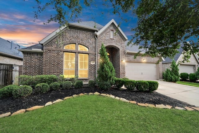 28430 Sycamore Falls Ln, Fulshear, TX 77441 - french country style house with brick siding, concrete driveway, and an attached garage