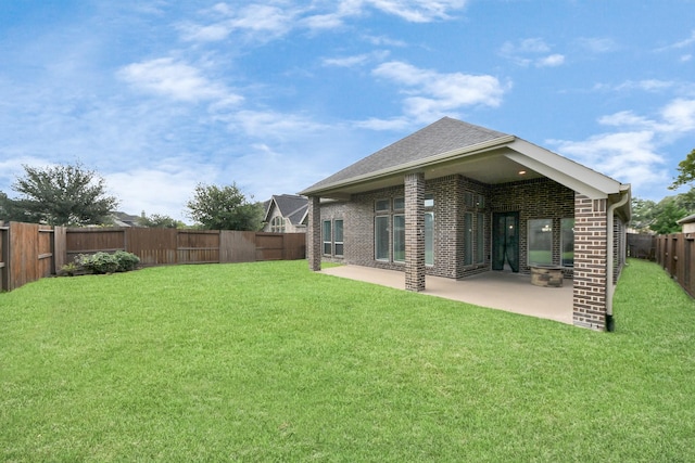 28430 Sycamore Falls Ln, Fulshear, TX 77441 - rear view of house featuring a fenced backyard, brick siding, a patio area, and roof with shingles