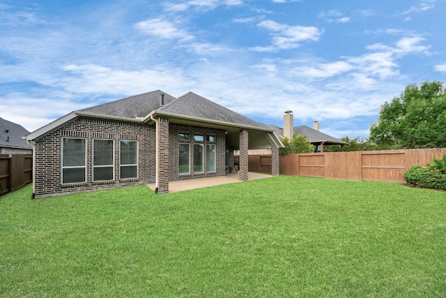 28430 Sycamore Falls Ln, Fulshear, TX 77441 - back of property with a fenced backyard, a patio area, brick siding, and roof with shingles
