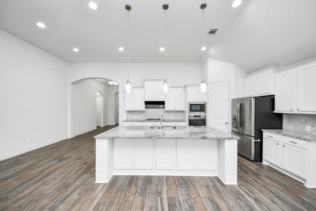 28430 Sycamore Falls Ln, Fulshear, TX 77441 - kitchen featuring stainless steel appliances, arched walkways, under cabinet range hood, tasteful backsplash, and white cabinetry
