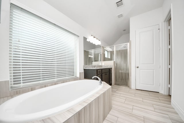 28430 Sycamore Falls Ln, Fulshear, TX 77441 - full bathroom with vanity, a stall shower, a bath, and vaulted ceiling