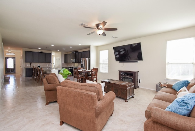 4302 Lisboa Cir, Katy, TX 77493 - living area with a ceiling fan, light tile patterned floors, and recessed lighting