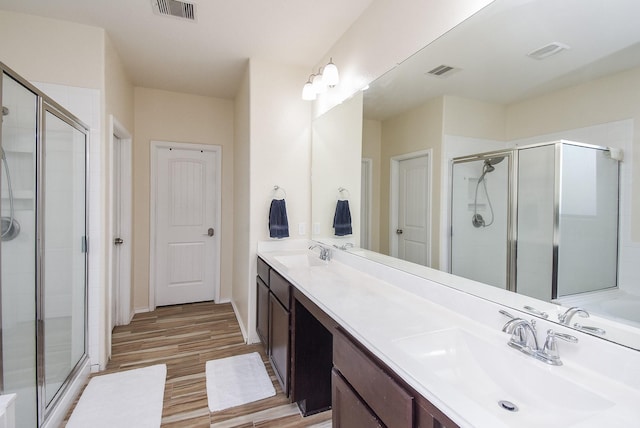 4302 Lisboa Cir, Katy, TX 77493 - full bath featuring a stall shower, double vanity, and wood finished floors