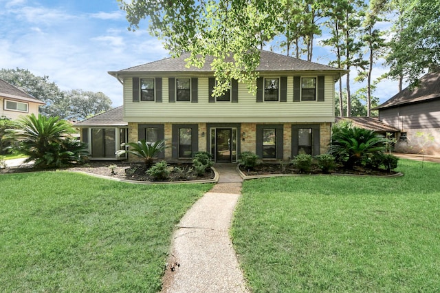 8311 Everleaf Dr, Spring, TX 77379 - view of front of home featuring a front lawn, roof with shingles, and brick siding