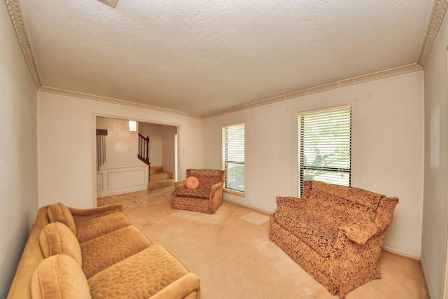 8311 Everleaf Dr, Spring, TX 77379 - living area featuring ornamental molding, stairway, light carpet, and a textured ceiling