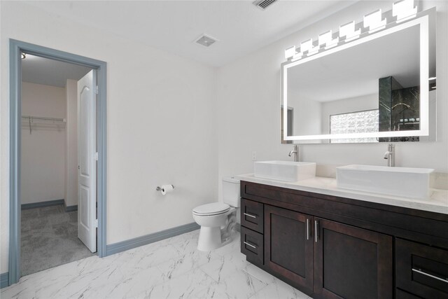 29418 Legends Hill Dr, Spring, TX 77386 - bathroom with double vanity, a walk in closet, marble look tiles, and a shower