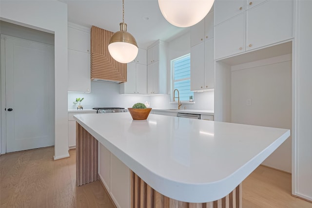 4109 Castor St Unit B, Houston, TX 77022 - kitchen with light wood-style flooring, light countertops, and white cabinetry