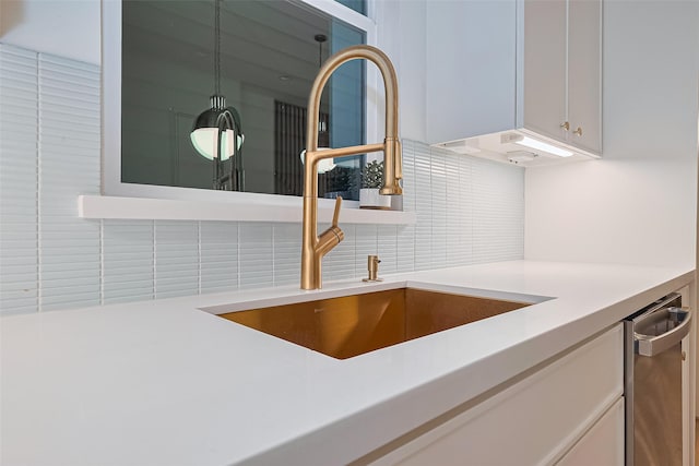 4109 Castor St Unit B, Houston, TX 77022 - kitchen view of decorative backsplash, light countertops, and white cabinets