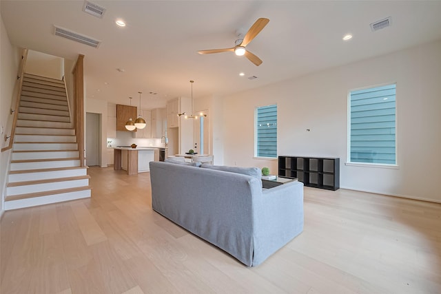 4109 Castor St Unit B, Houston, TX 77022 - living area with light wood-style floors, a ceiling fan, stairway, and recessed lighting