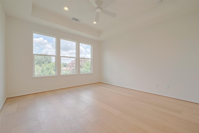 4109 Castor St Unit B, Houston, TX 77022 - unfurnished room featuring light wood-style flooring, a tray ceiling, ceiling fan, and recessed lighting