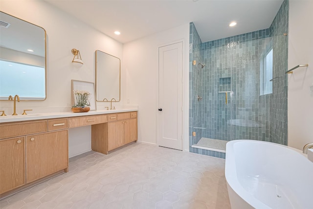 4109 Castor St Unit B, Houston, TX 77022 - full bathroom featuring a shower stall, double vanity, a soaking tub, recessed lighting, and tile patterned flooring