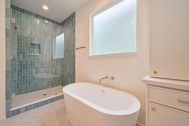 4109 Castor St Unit B, Houston, TX 77022 - full bathroom with a freestanding tub, a shower stall, recessed lighting, and tile patterned flooring