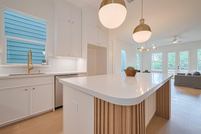 4109 Castor St Unit B, Houston, TX 77022 - kitchen with dishwasher, white cabinets, a center island, open floor plan, and light countertops