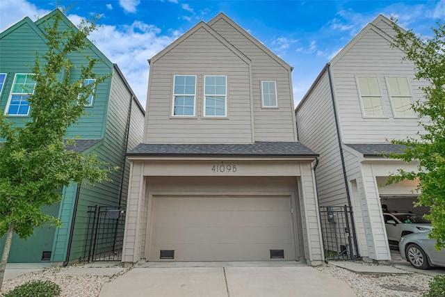 4109 Castor St Unit B, Houston, TX 77022 - view of front of house featuring driveway, roof with shingles, an attached garage, and a gate