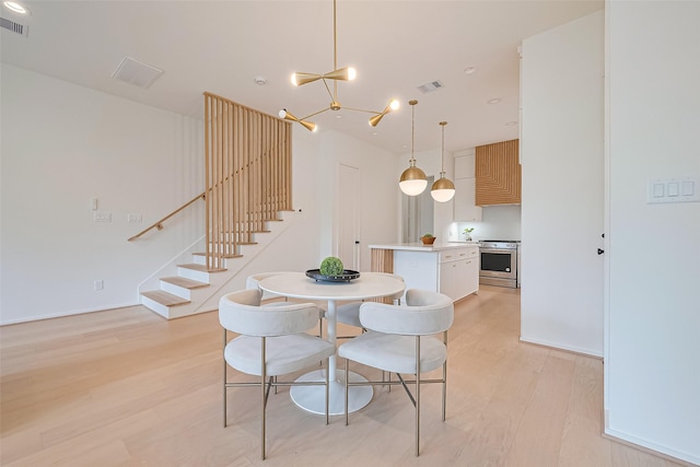 4109 Castor St Unit B, Houston, TX 77022 - dining area with stairs, light wood finished floors, and a chandelier