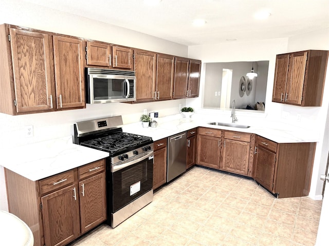 10934 Covered Bridge St, Houston, TX 77075 - kitchen with appliances with stainless steel finishes, light countertops, brown cabinets, and recessed lighting