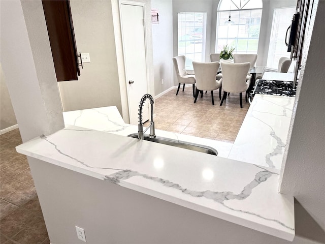 10934 Covered Bridge St, Houston, TX 77075 - kitchen featuring a sink and light stone countertops