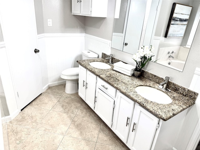10934 Covered Bridge St, Houston, TX 77075 - bathroom with double vanity, tile patterned floors, and wainscoting