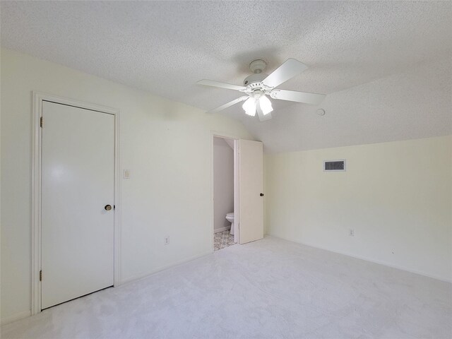 3 Thunderbird Cir, Baytown, TX 77521 - unfurnished bedroom featuring vaulted ceiling, a textured ceiling, carpet floors, a ceiling fan, and ensuite bath