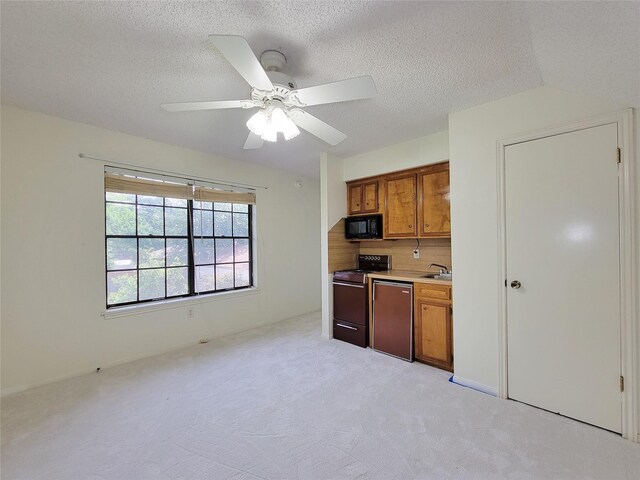 3 Thunderbird Cir, Baytown, TX 77521 - kitchen featuring electric range oven, black microwave, dishwashing machine, brown cabinets, and ceiling fan