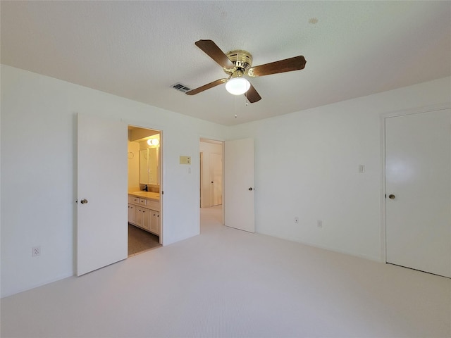 3 Thunderbird Cir, Baytown, TX 77521 - unfurnished bedroom featuring connected bathroom, light colored carpet, and a ceiling fan