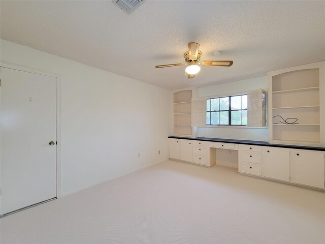 3 Thunderbird Cir, Baytown, TX 77521 - unfurnished office featuring built in desk, ceiling fan, a textured ceiling, and light carpet