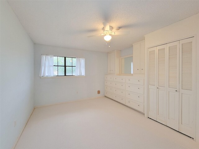 3 Thunderbird Cir, Baytown, TX 77521 - unfurnished bedroom featuring light carpet, a closet, ceiling fan, and a textured ceiling