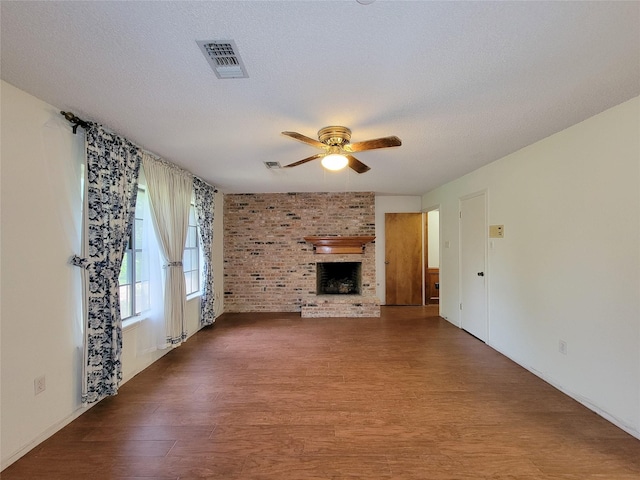 3 Thunderbird Cir, Baytown, TX 77521 - unfurnished living room with ceiling fan, wood finished floors, and a brick fireplace