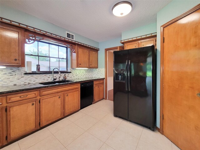 3 Thunderbird Cir, Baytown, TX 77521 - kitchen with black appliances, brown cabinets, tasteful backsplash, a textured ceiling, and light tile patterned floors