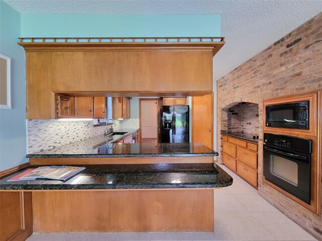 3 Thunderbird Cir, Baytown, TX 77521 - kitchen with black appliances, brown cabinets, decorative backsplash, a textured ceiling, and a peninsula