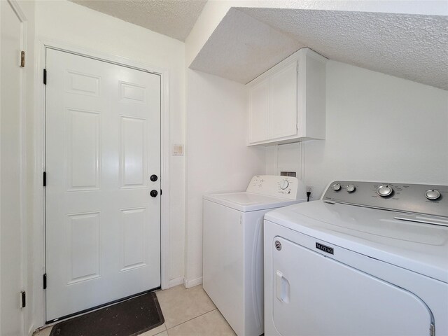 3 Thunderbird Cir, Baytown, TX 77521 - washroom with cabinet space, separate washer and dryer, a textured ceiling, and light tile patterned floors