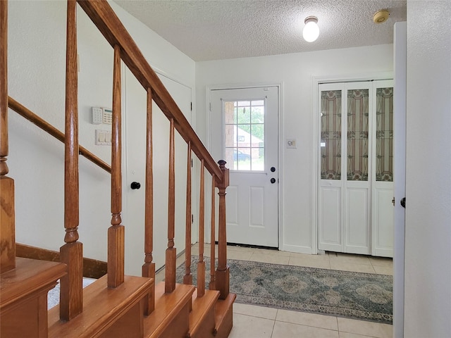 3 Thunderbird Cir, Baytown, TX 77521 - tiled entryway with stairway and a textured ceiling
