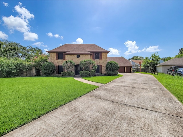 3 Thunderbird Cir, Baytown, TX 77521 - traditional-style home with a garage, a front yard, brick siding, and driveway