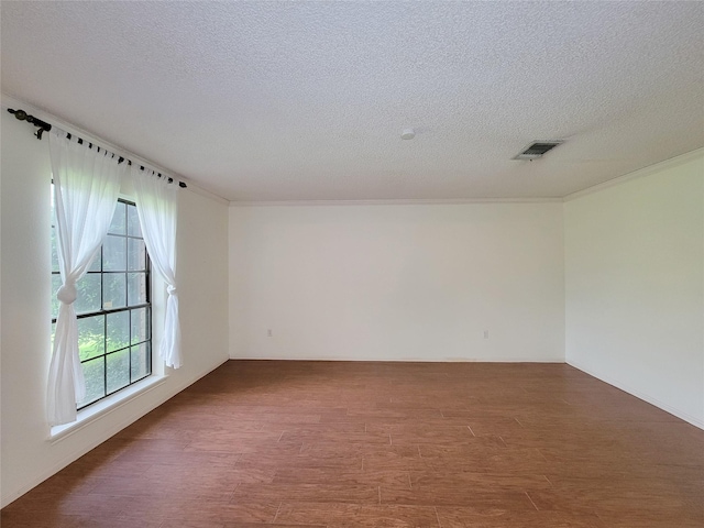 3 Thunderbird Cir, Baytown, TX 77521 - empty room featuring a textured ceiling, wood finished floors, and ornamental molding