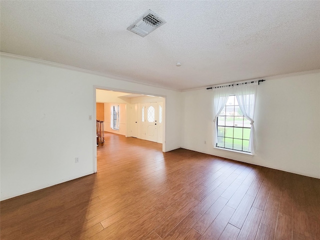 3 Thunderbird Cir, Baytown, TX 77521 - empty room with a textured ceiling, wood finished floors, and crown molding