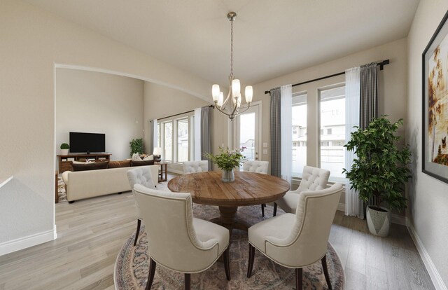 12611 Faded Sky Ct, Cypress, TX 77433 - dining area featuring light wood-style flooring, a chandelier, and vaulted ceiling