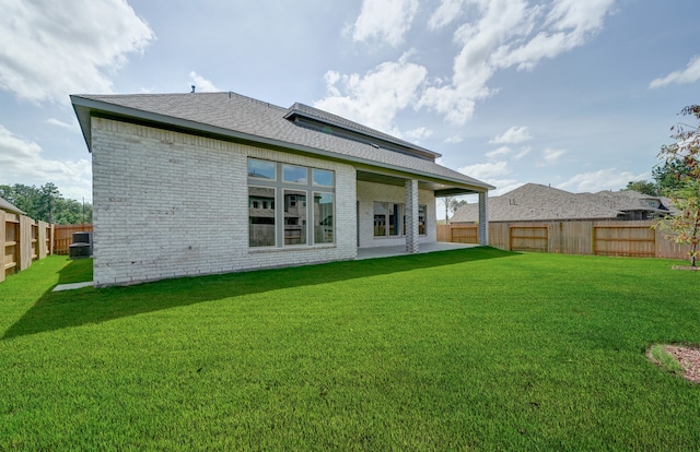 12611 Faded Sky Ct, Cypress, TX 77433 - rear view of house featuring a fenced backyard, brick siding, a shingled roof, and a patio area
