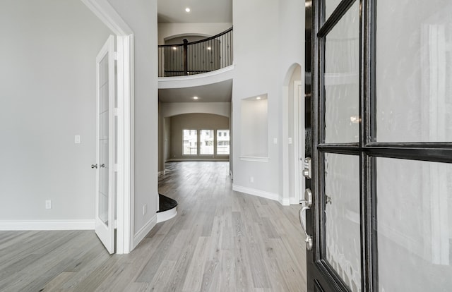 12611 Faded Sky Ct, Cypress, TX 77433 - foyer entrance featuring arched walkways, wood finished floors, and a towering ceiling