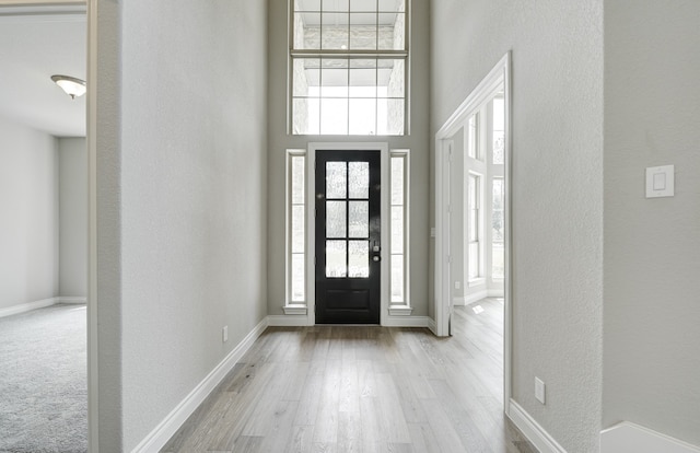 12611 Faded Sky Ct, Cypress, TX 77433 - foyer featuring wood finished floors, a high ceiling, and a textured wall