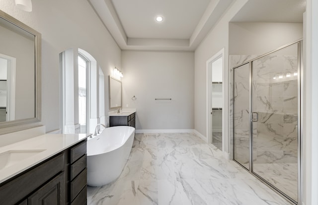 12611 Faded Sky Ct, Cypress, TX 77433 - bathroom featuring a marble finish shower, marble look tiles, two vanities, a freestanding bath, and a walk in closet